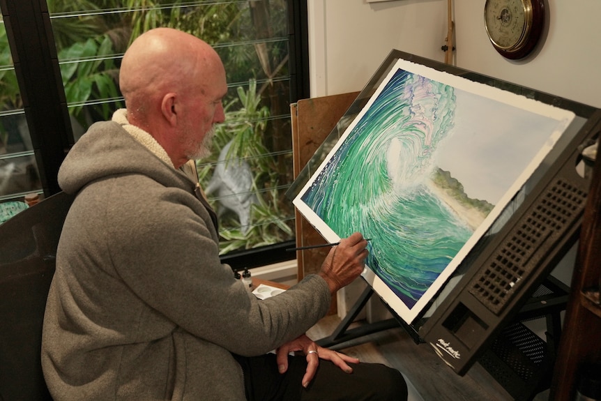 Colin painting a wave.