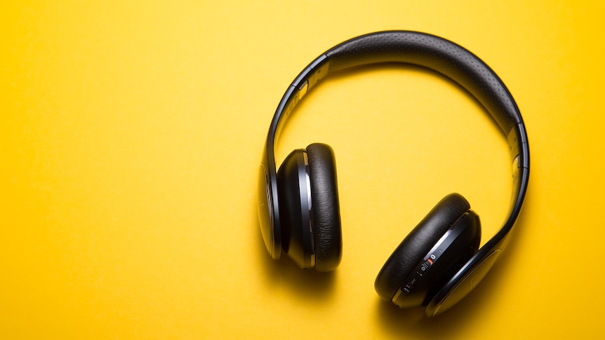 Photo of black headphones on a yellow background