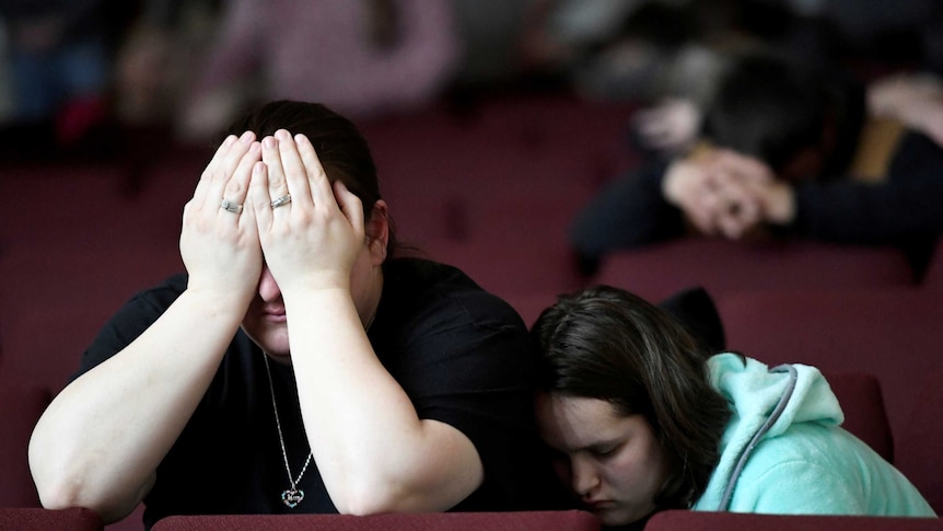 A mother and daughter attend a prayer vigil following a Kentucky school shooting in January.