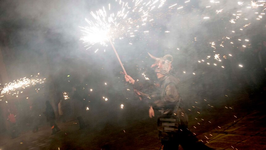 Villagers take part in the burning of 'El Judas' in the village of Villadiego, northern Spain