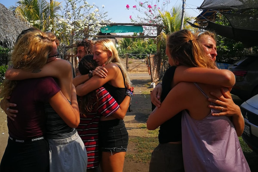 A group of friends hug goodbye in Guatemala.