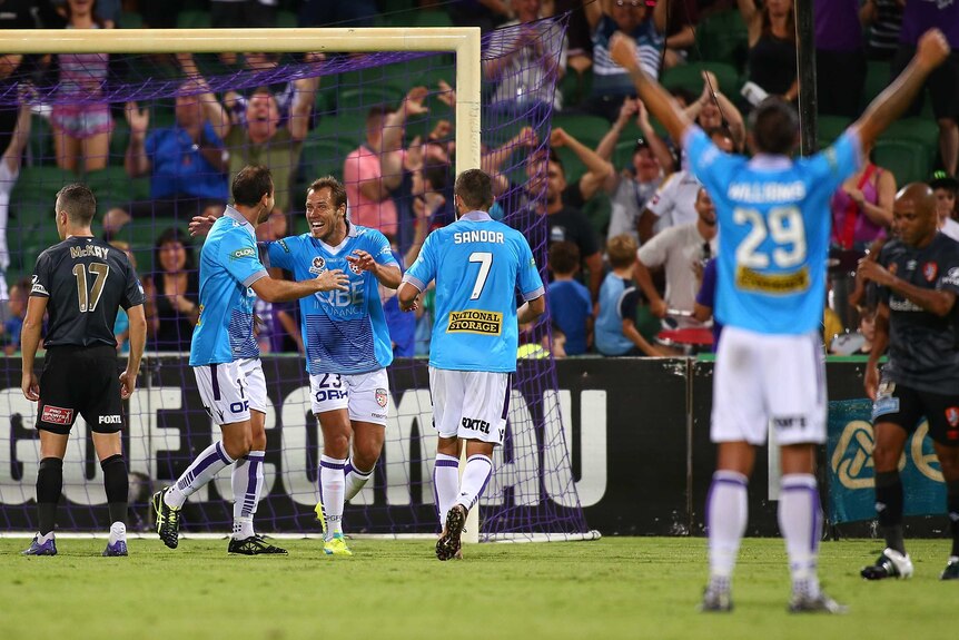 Perth Glory;'s Richard Garcia and Krisztian Vadocz celebrate a goal against Brisbane Roar.