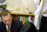 Tony Abbott with a mother and her baby