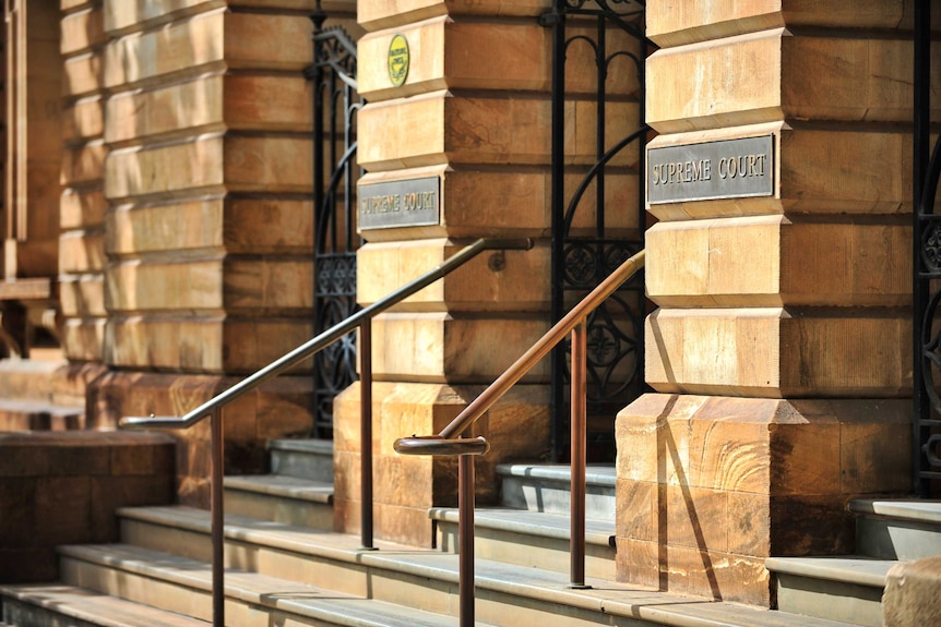 a building exterior with "supreme court" signage