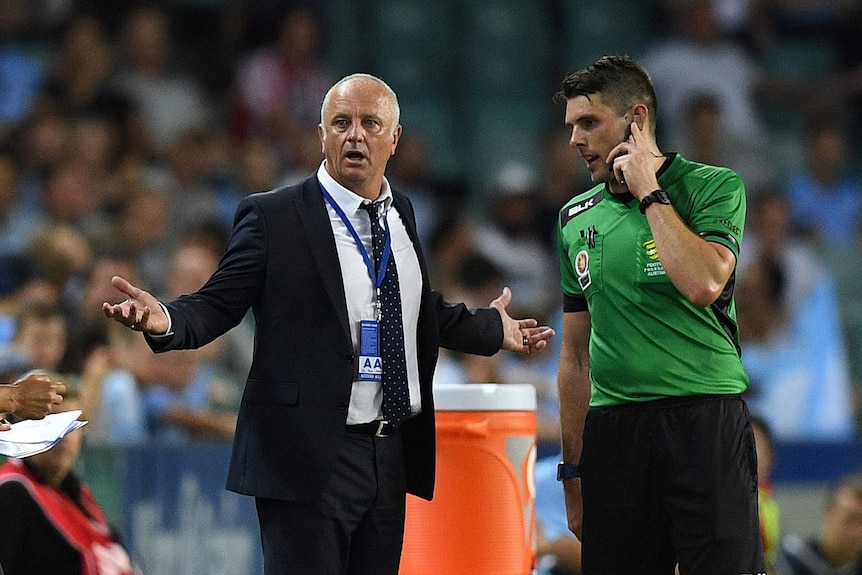 Sydney coach Graham Arnold gestures to the fourth official