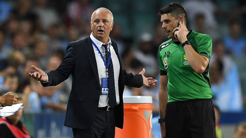 Sydney coach Graham Arnold gestures to the fourth official