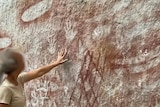 A woman touching rocks