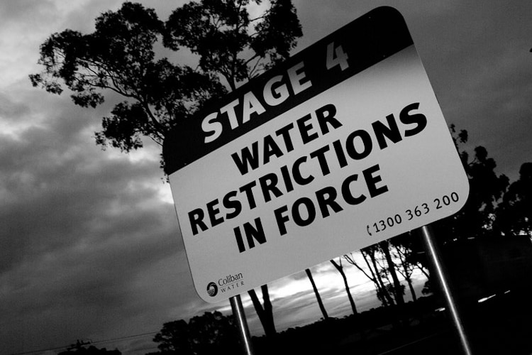 A sign showing water restrictions in place