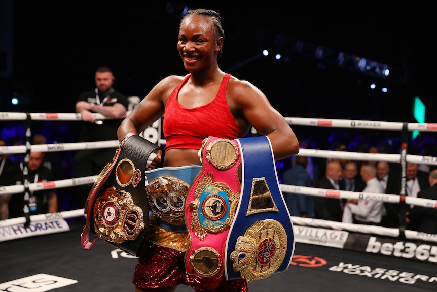 Claressa Shields holds five boxing belts and smiles