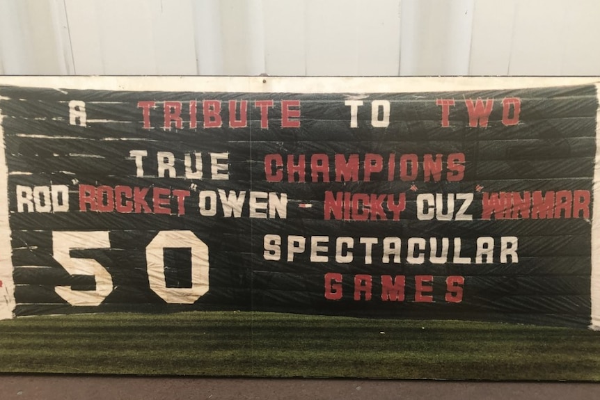 The 50th game banner made for Rod Owen in 1989 says 'a tribute to two true champions, Rod 'Rocket' Owen and Nicky 'Cuz' Winmar.
