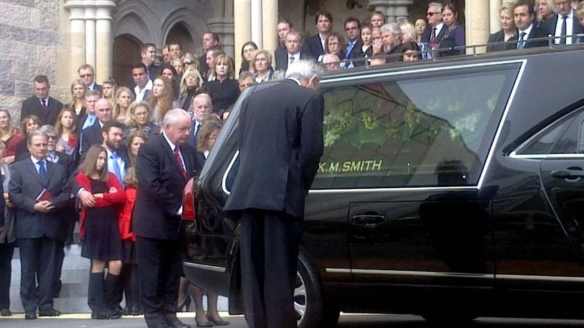 The coffin of mining magnate Ken Talbot lies in the back of a hearse outside St John's Cathedral.