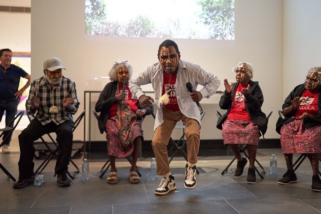 Pedro Wonaeamirri dances wearing face paint at the opening of the Adelaide Biennial