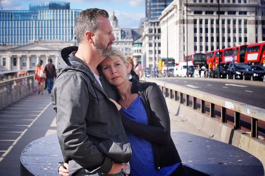 Mark and Julie Wallace hug on London Bridge where their daughter Sara Zelenak was killed.
