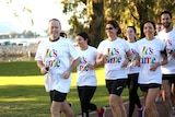 A smiling Bill Shorten leads a pack of joggers wearing "It's Time" t-shirts.