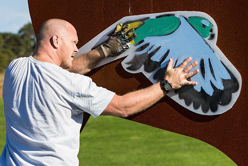 Mike McLean with parrot mural