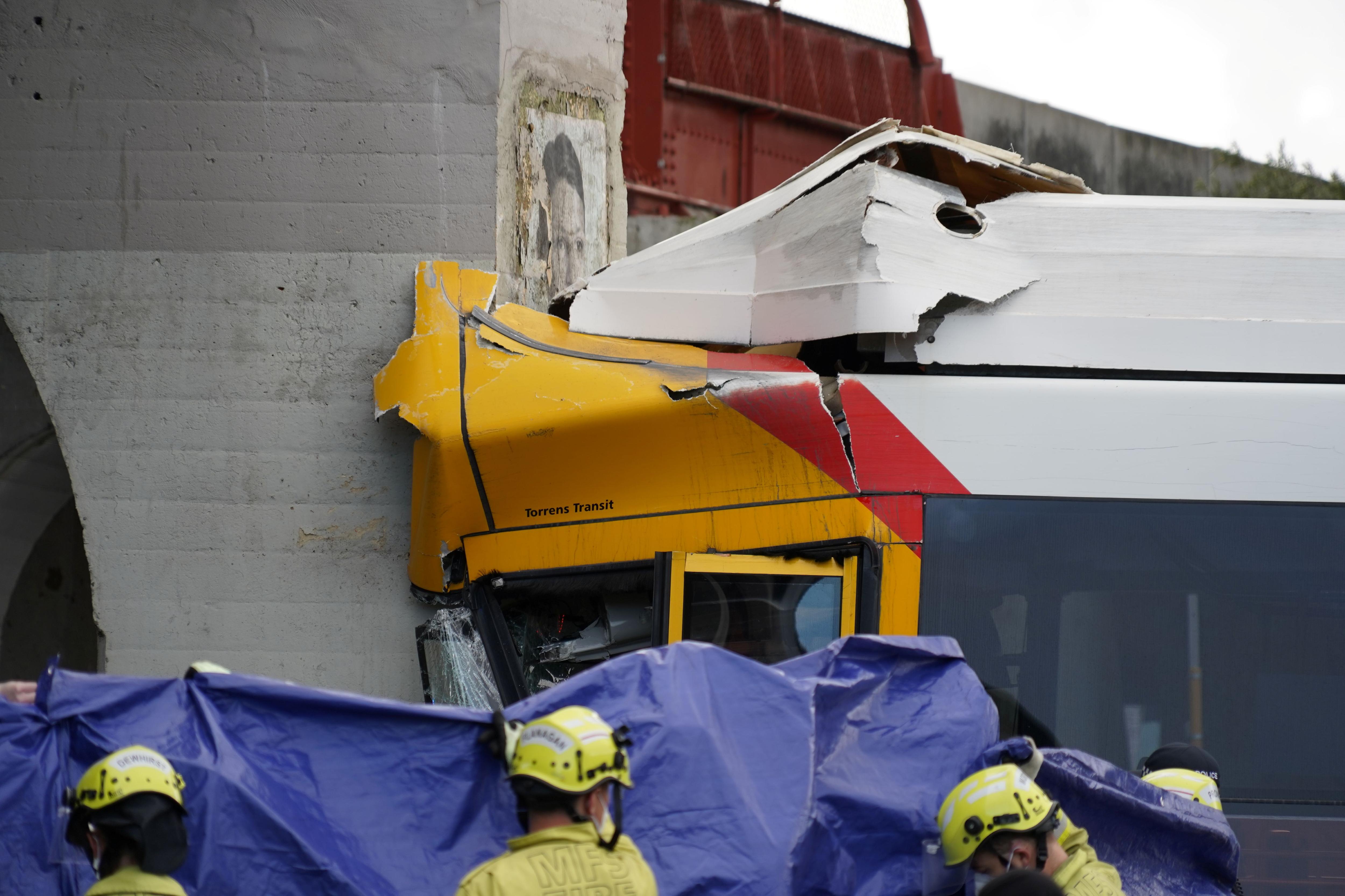 Driver, passenger trapped as bus crashes into train bridge