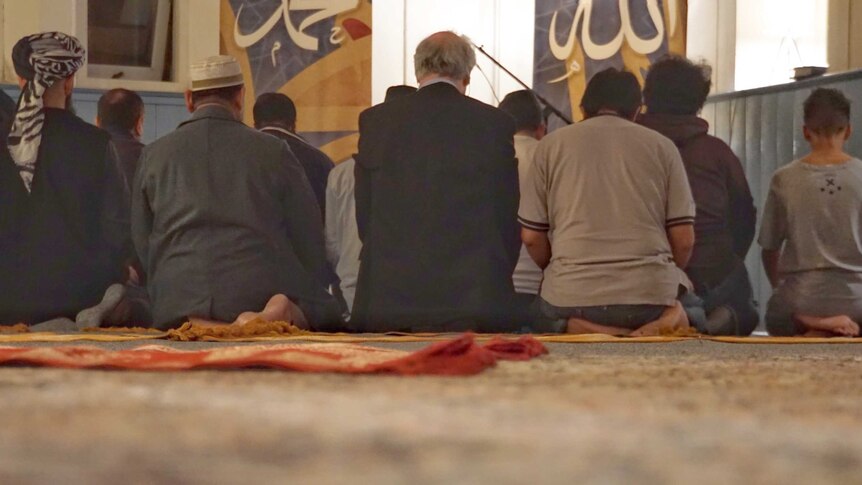 Muslims on a mat in a church praying.