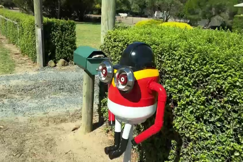 A Jockey minion with a black cap, red body and a horse in the background