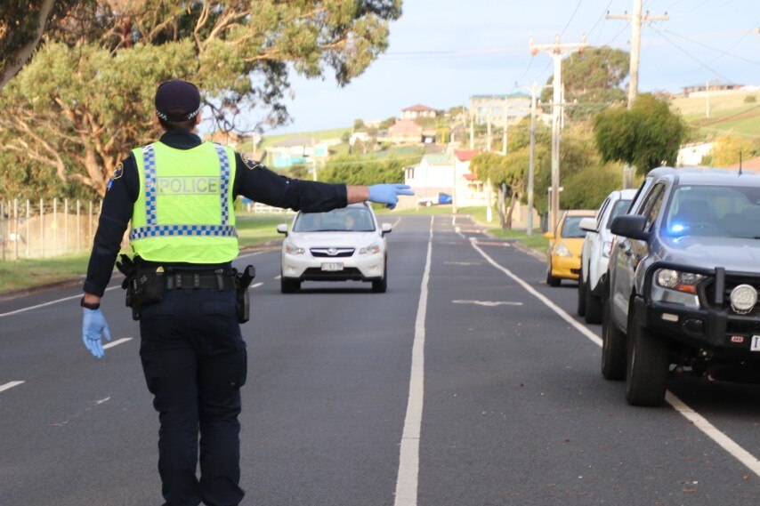 A police officer waves down a car in Tasmania