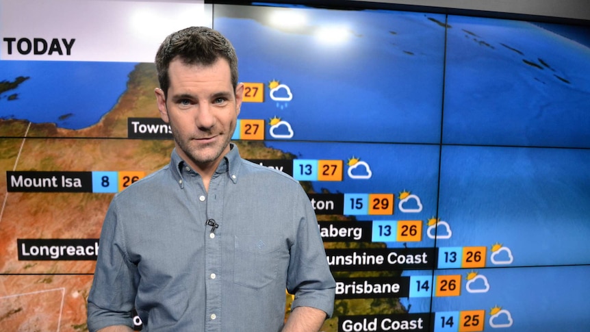 ABC weather presenter Nate Byrne standing in the TV studio.