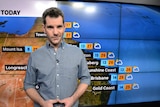 ABC weather presenter Nate Byrne standing in the TV studio.