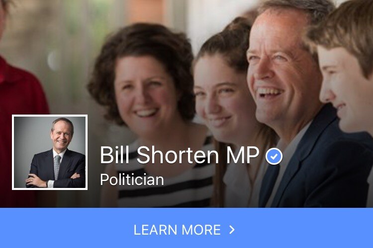 Bill Shorten smiling with three young people and a woman.