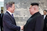 North Korean leader Kim Jong Un, right, and South Korean President Moon Jae-in, left, shake hands