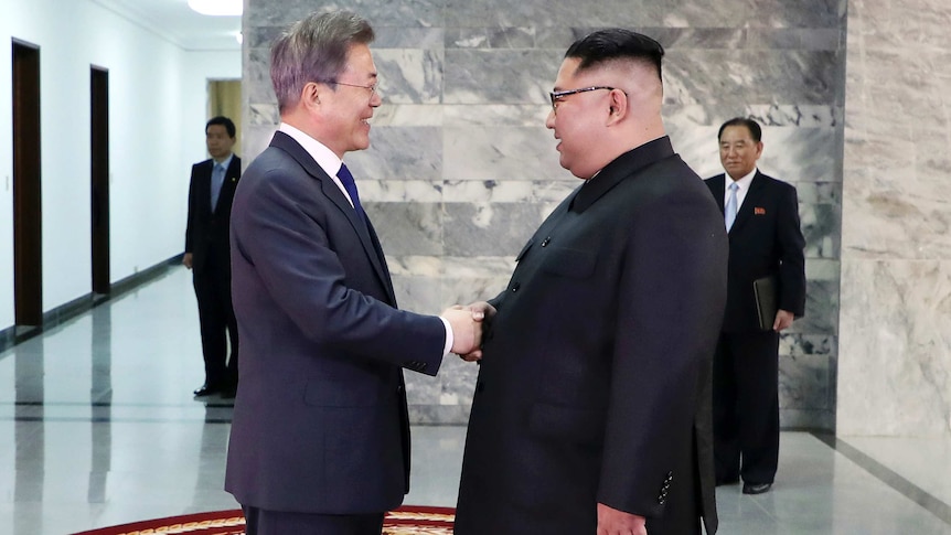 North Korean leader Kim Jong Un, right, and South Korean President Moon Jae-in, left, shake hands