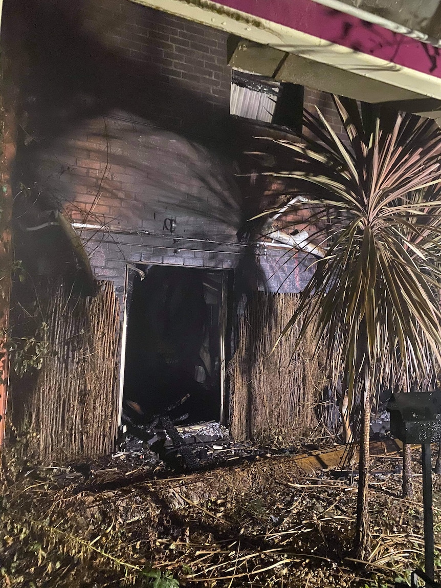 A burnt out doorway on a brick building