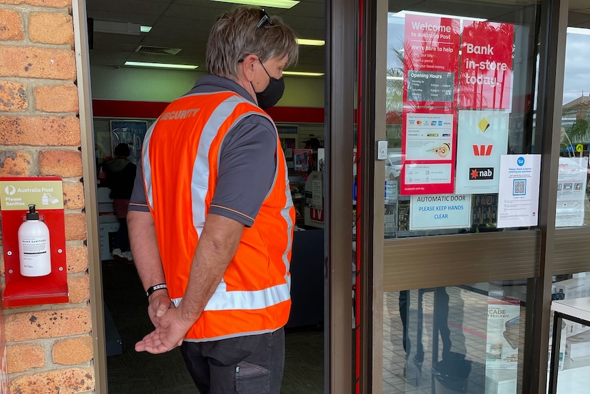security officer with mask standing outside Mullumbimby post office
