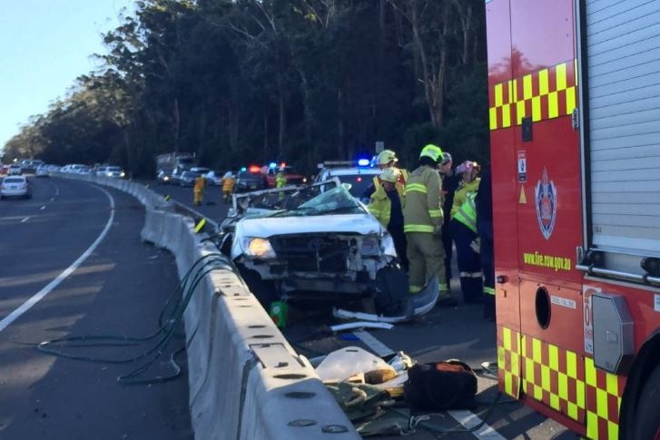 A crushed ute and emergency services on the M1 Princes Motorway.