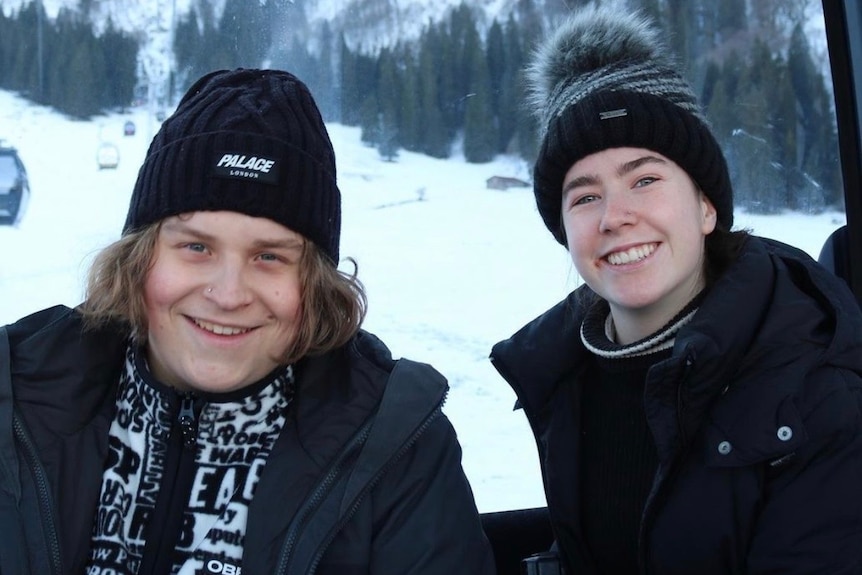 Two teenagers in the snow.