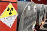 Signage and metal drums containing uranium.