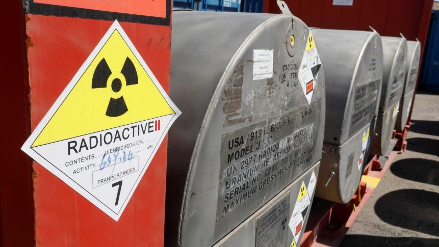 Signage and metal drums containing uranium.