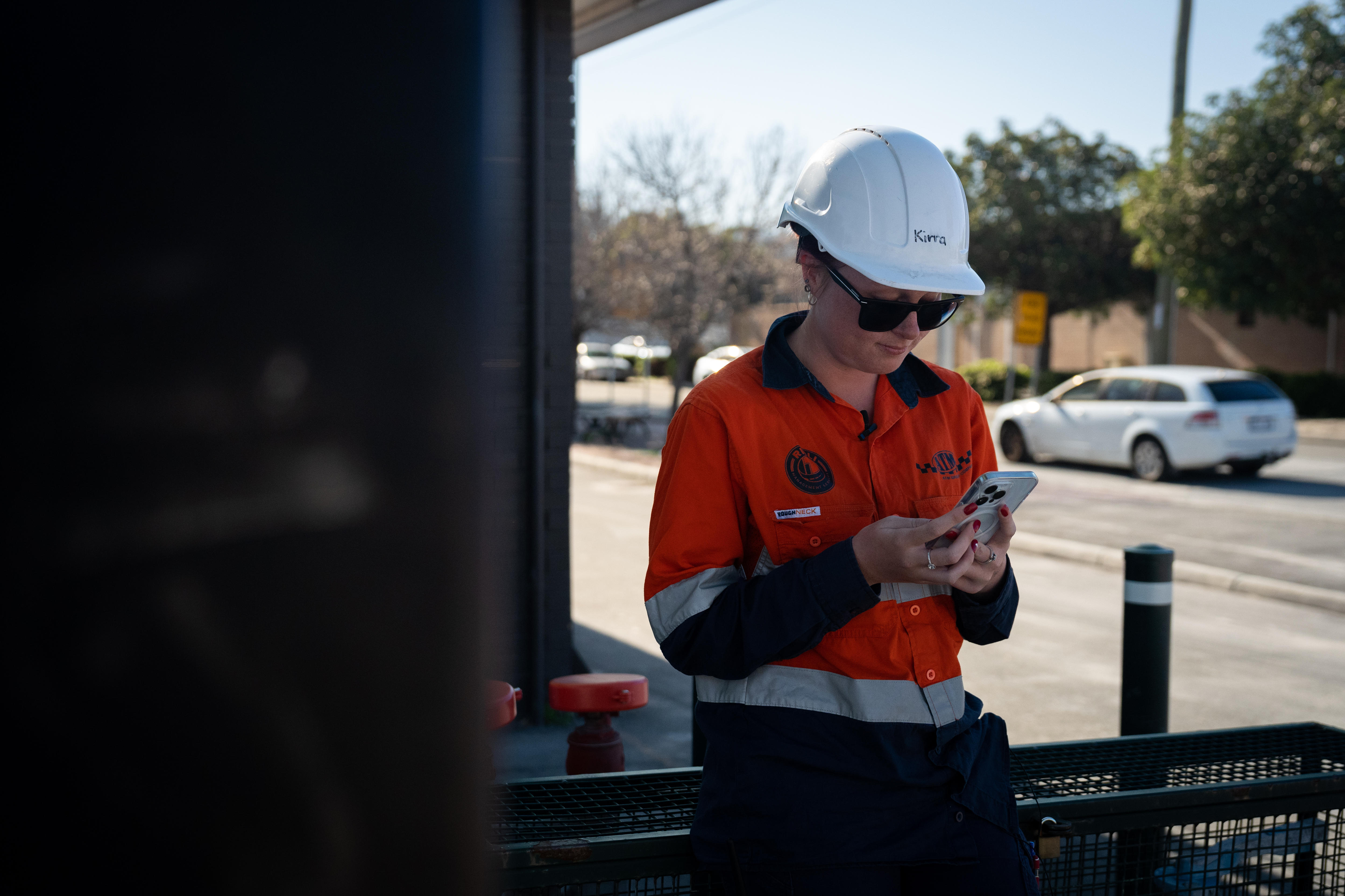 A woman in work gear standing on a road