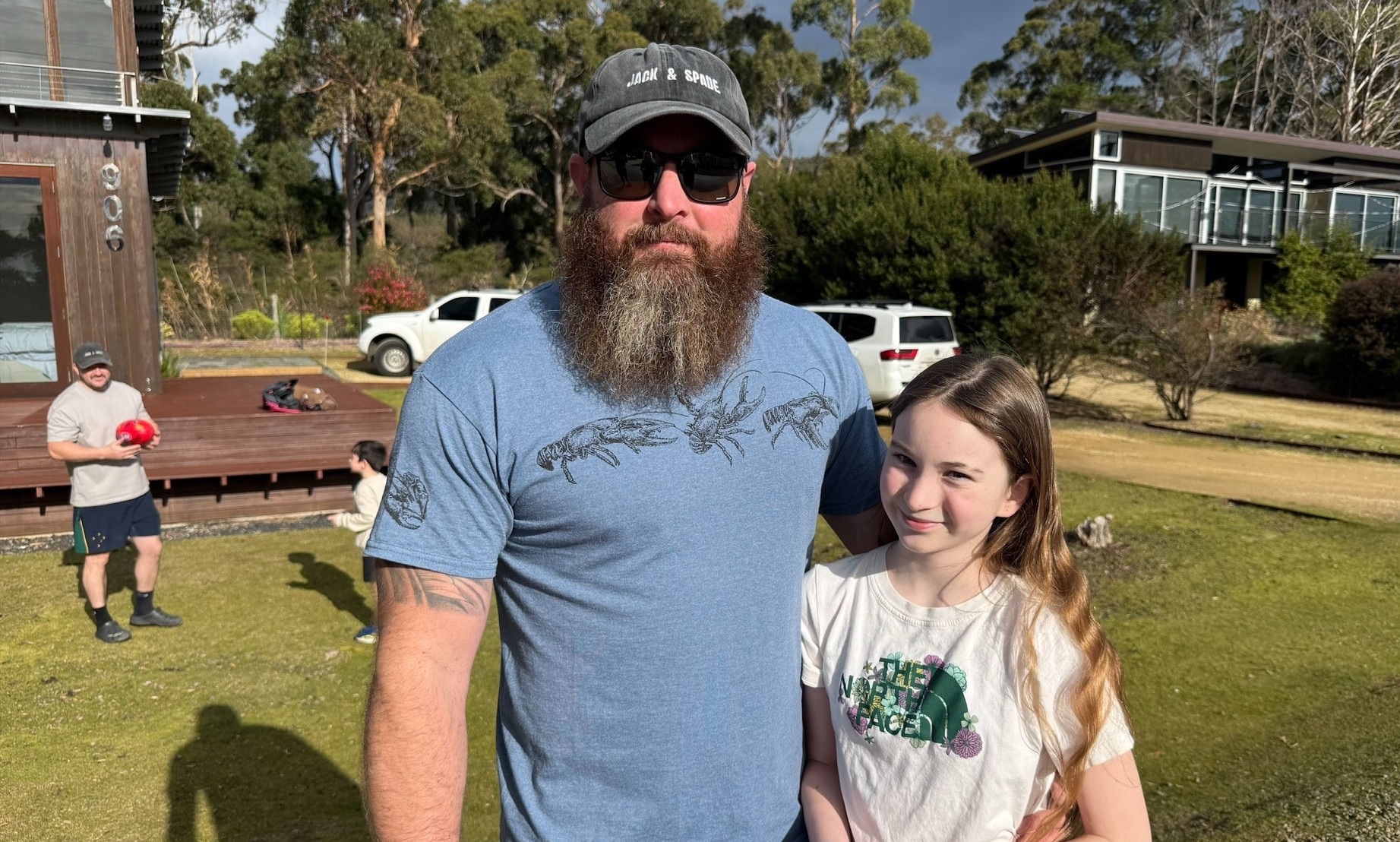 A man and a young girl pose for a photo.