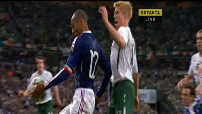 Lending a hand ... Thierry Henry handballs against Ireland