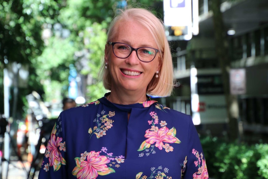 Melbourne Lord Mayor Sally Capp smiles as she poses for a photo on a Melbourne street.