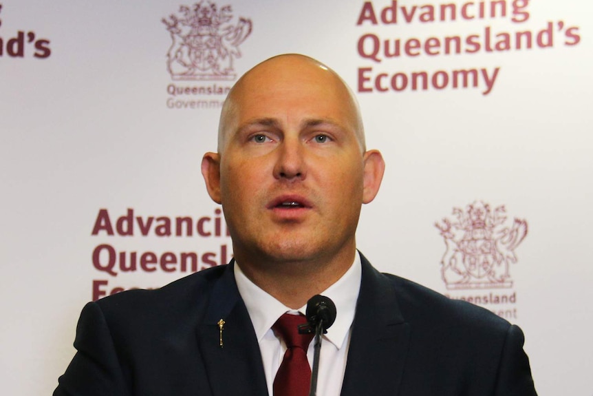 Former treasurer Curtis Pitt speaks to the media at a podium in the Queensland budget lock-up.