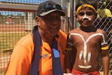 Djarindjin Airport Manager Kimberley Baird with young Indigenous boy outside airport.