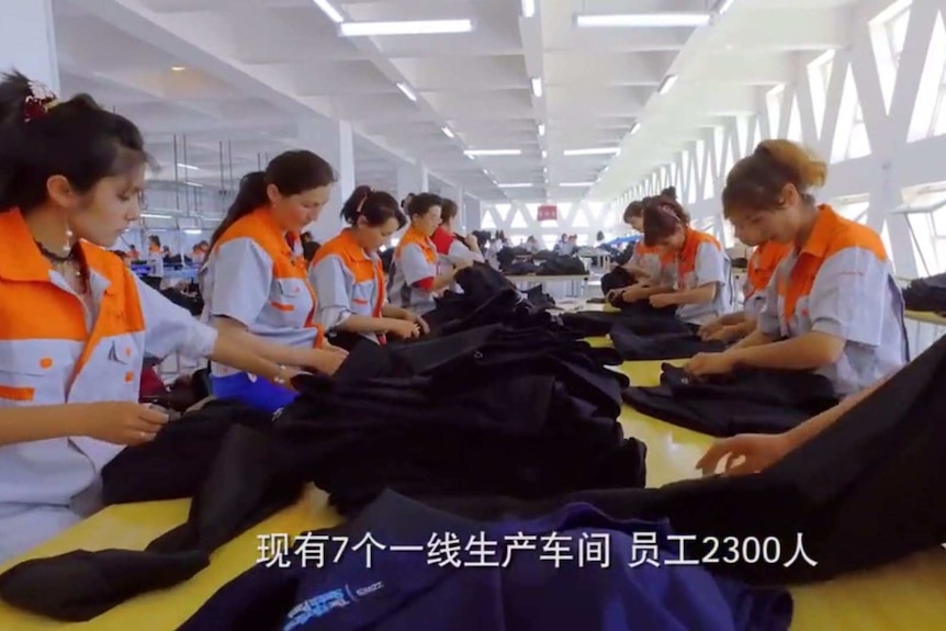 Golden Future employees check pants at a factory in Xinjiang. The label of a pair of Croft & Barrow pants is visible.