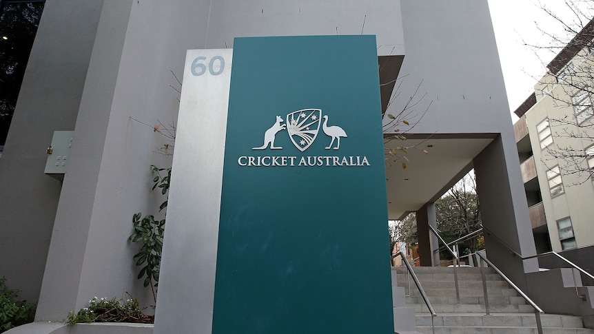 A sign next to the steps outside a city office building reads 'Cricket Australia'.
