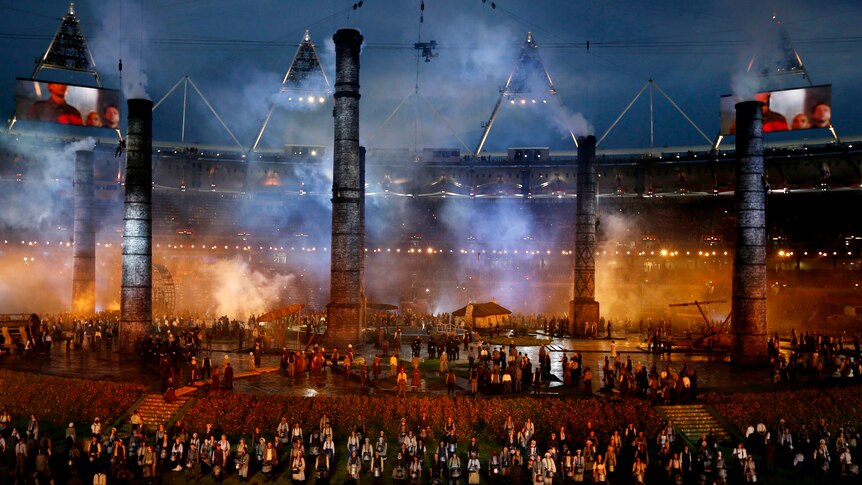 Smoke stacks from the industrial age appear during the opening ceremony.