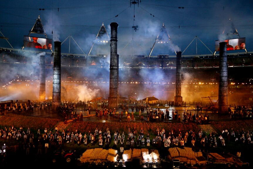 Smoke stacks from the industrial age appear during the opening ceremony.
