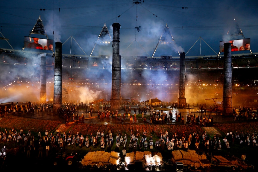 Smoke stacks from the industrial age appear at the opening ceremony of the London Olympic Games.