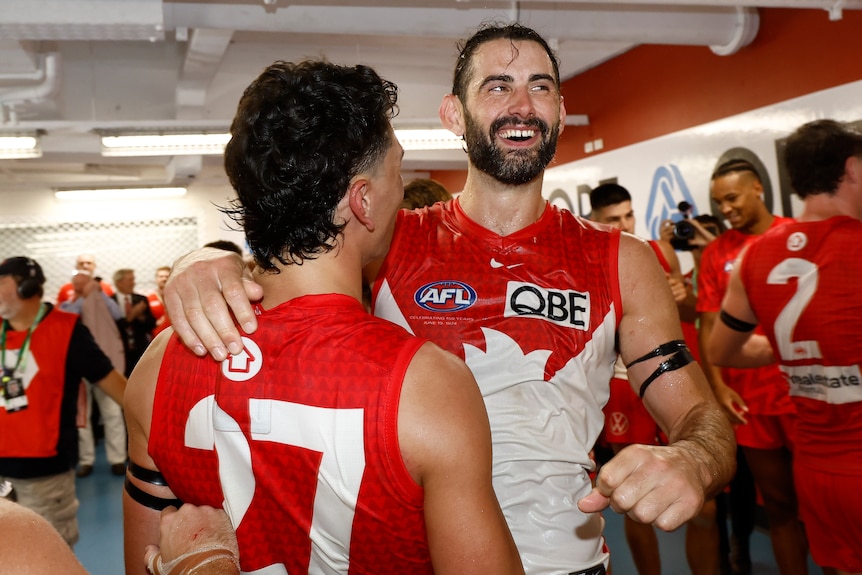 Brodie Grundy celebrates a laugh with Justin McInerney