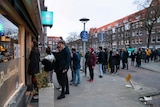 People queue to buy marijuana at coffeeshop Bulwackie in Amsterdam.