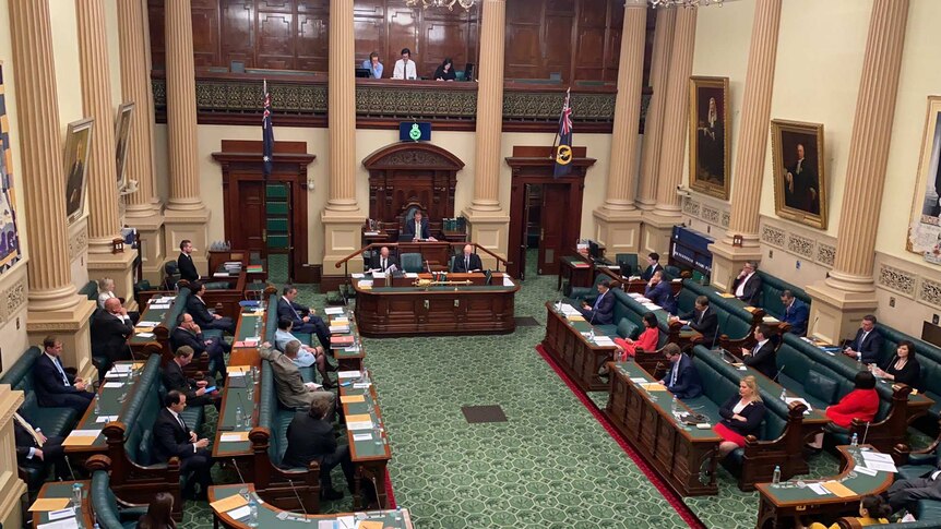 Inside a green parliamentary chamber