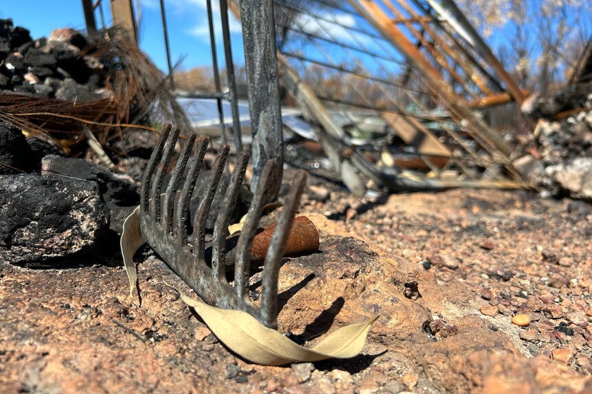 a close up image of the head of a rake, burned by fire