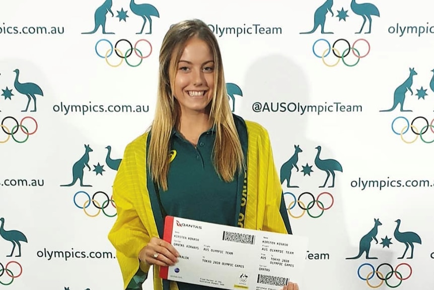 Australian Artistic Swimmer Kirsten Kinash holding a plane ticket to Tokyo Olympics.